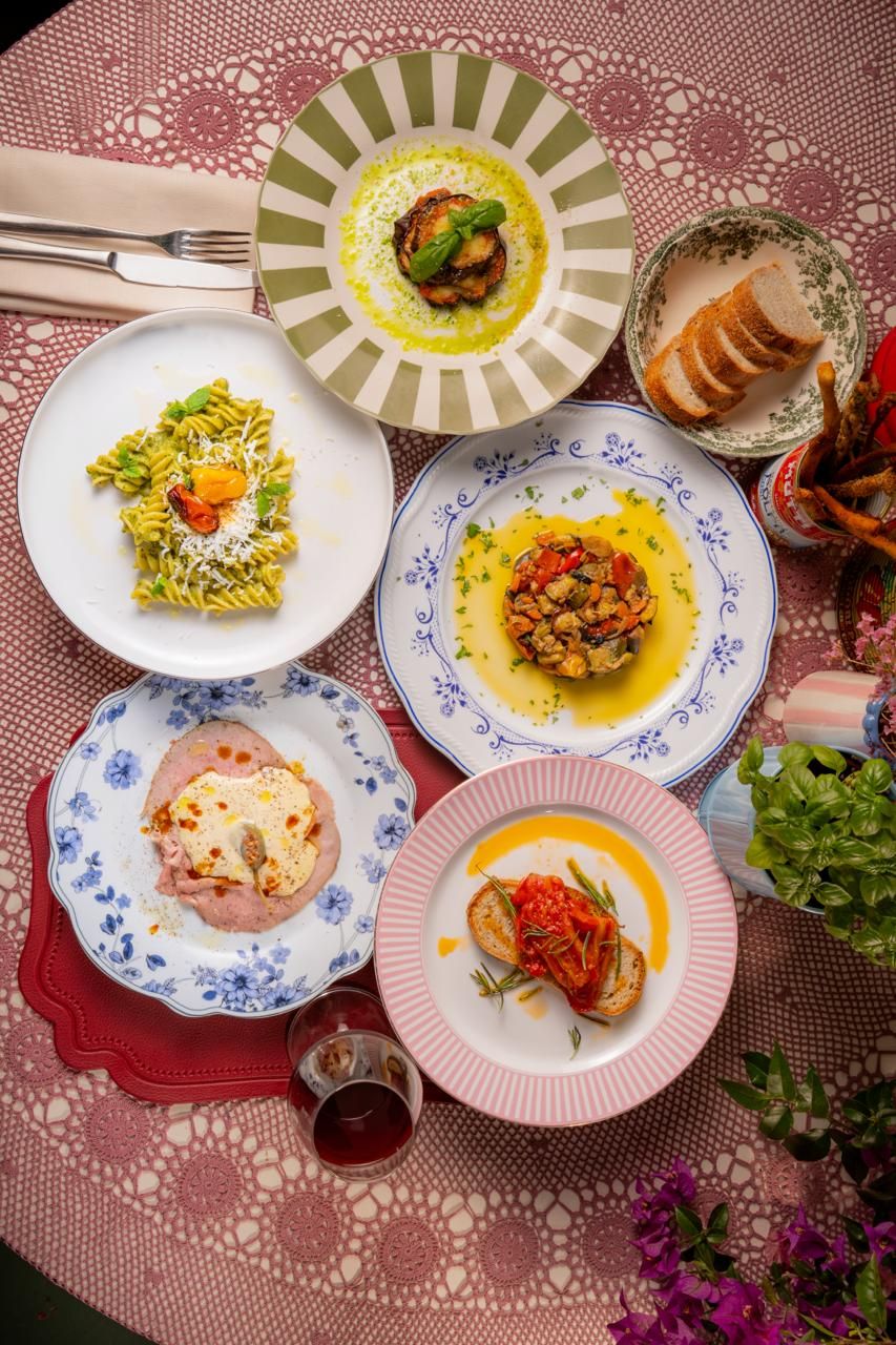 Tavola imbandita con antipasti, pasta e bruschette